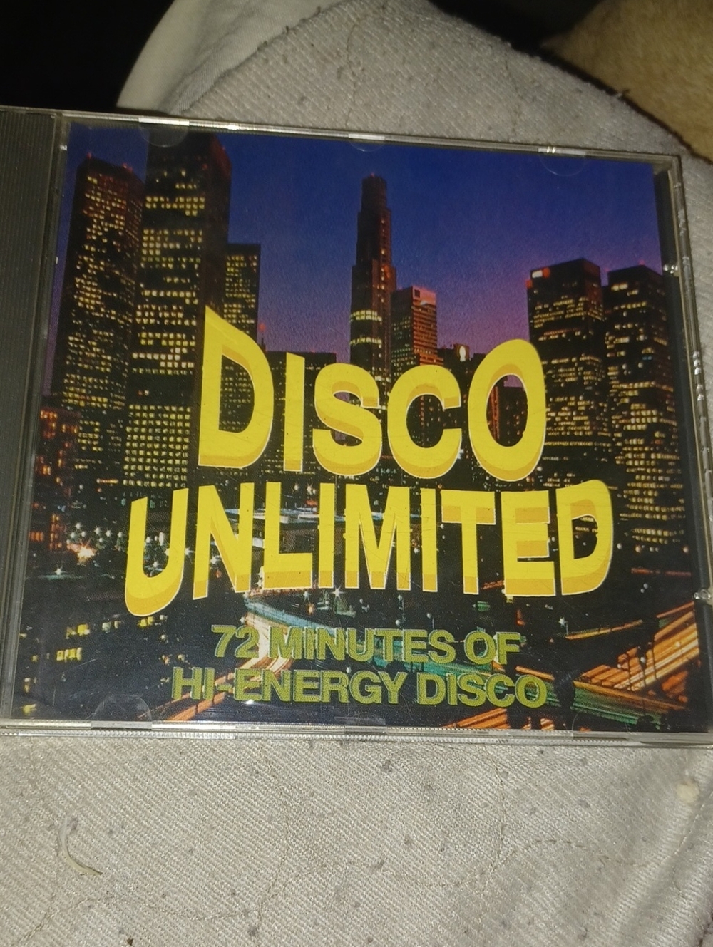 Disco Unlimited CD - Yellow Title Cityscape Cover